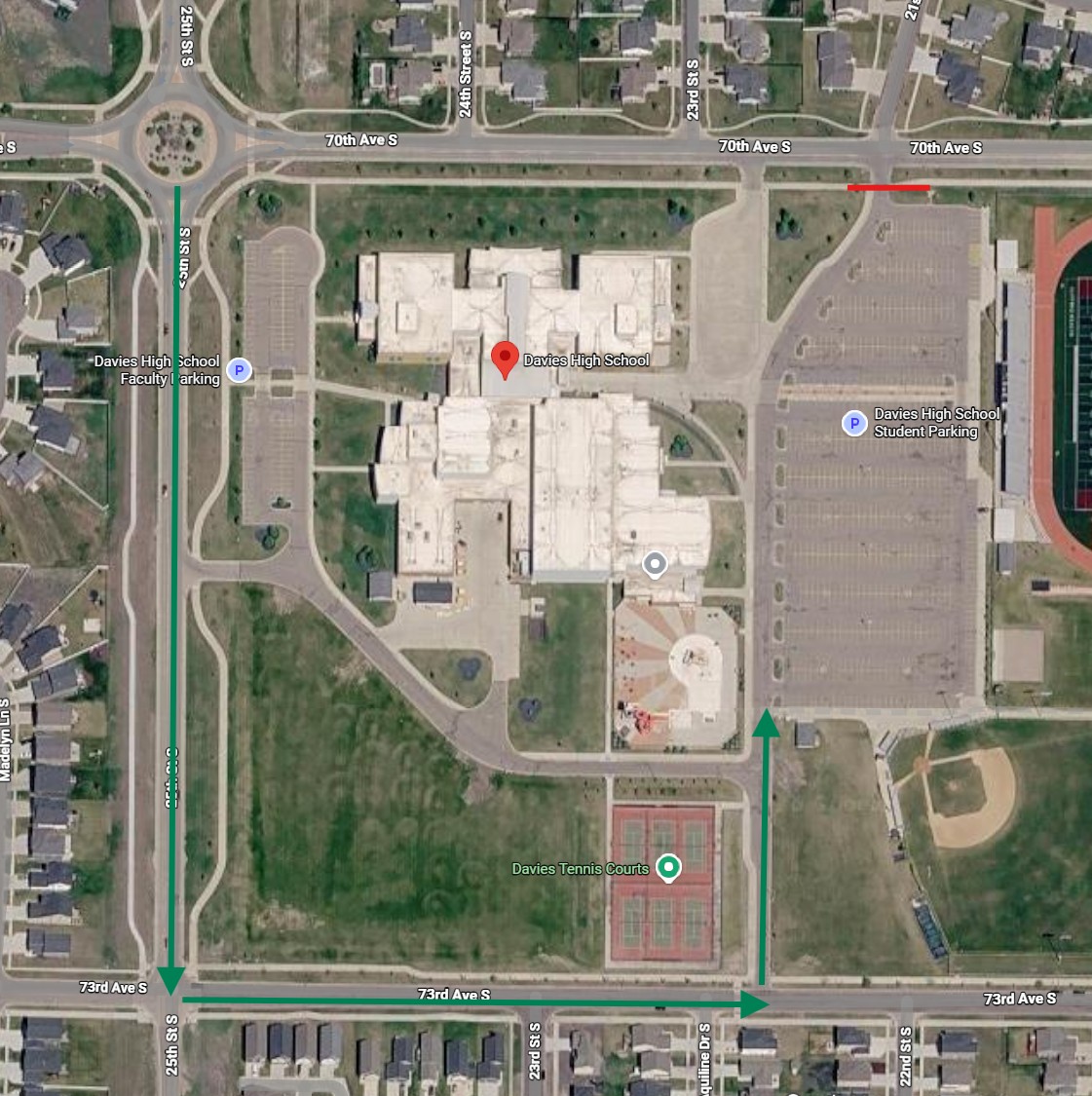 Aerial map of Davies High School showing a designated construction detour route. Green arrows direct traffic south on 25th Street South, east on 73rd Avenue South, and north into the southeast entrance near the student parking lot. A red line marks a closure or restricted access point along 70th Avenue South near the northeast side of campus. The school building, parking lots, tennis courts, and surrounding streets are labeled.
