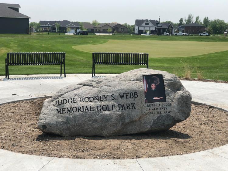judgerodneywebbmemorialrock This image shows the memorial rock at the Judge Rodney Webb Memorial Golf Park.