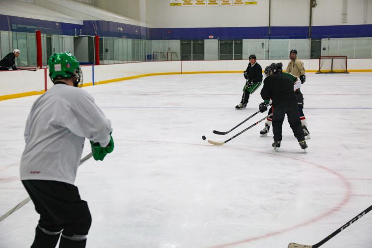 dropinhockey_2 This image shows men skating on the ice at Drop In Hockey.