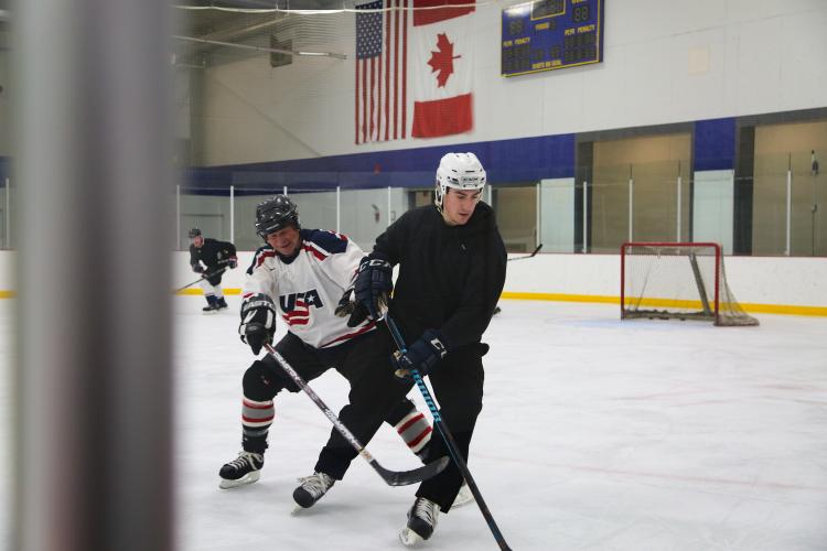 dropinhockey_3 This image shows men skating on the ice at Drop In Hockey.