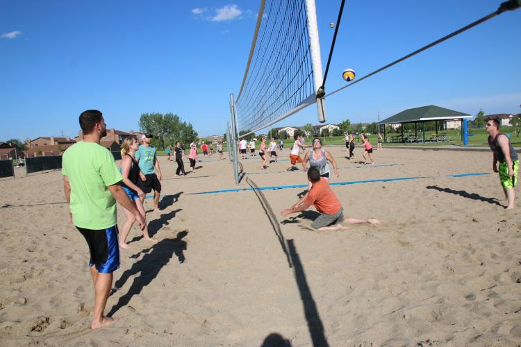This image shows a sand volleyball match being played.