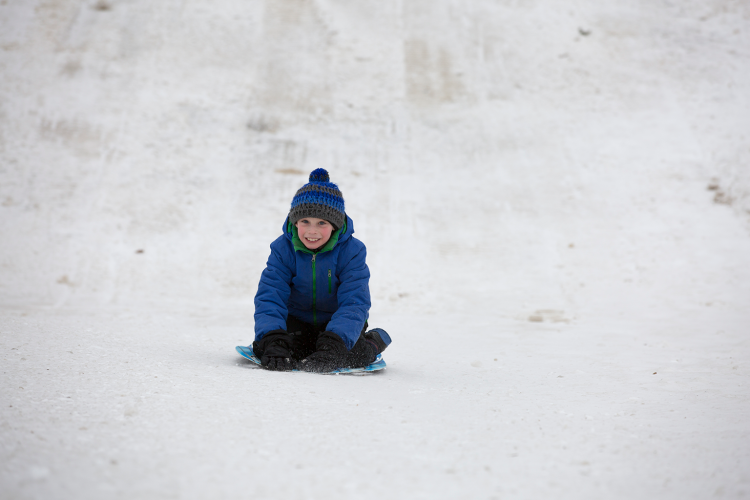 sledding_1 This image shows a boy sledding.