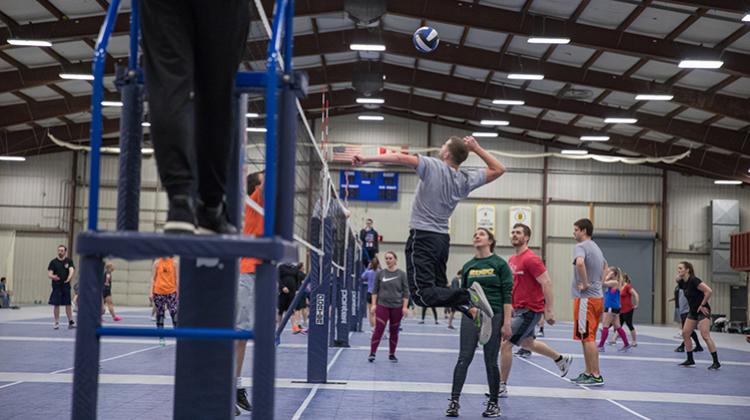 This image shows a male volleyball player spiking the ball./