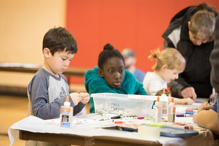 This image shows a boy and girl working on their projects during an art class.