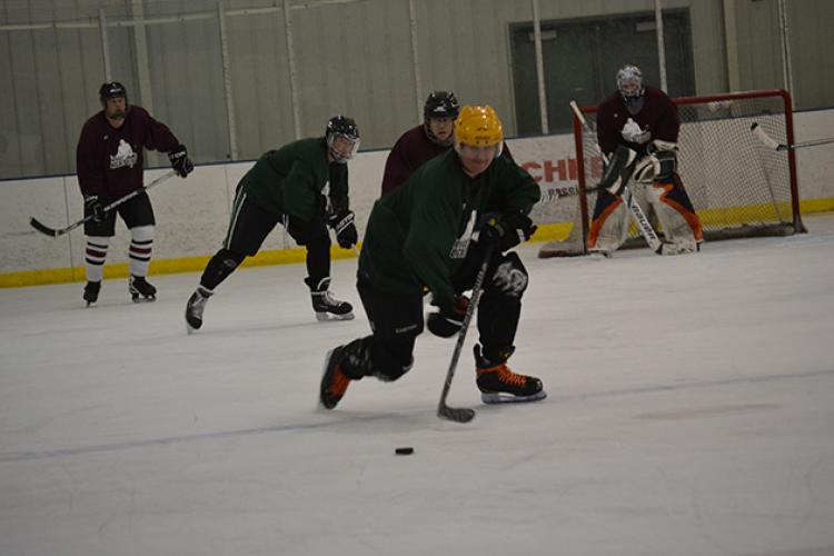 hockeyadult This image shows a player skating the puck up the ice at adult hockey.