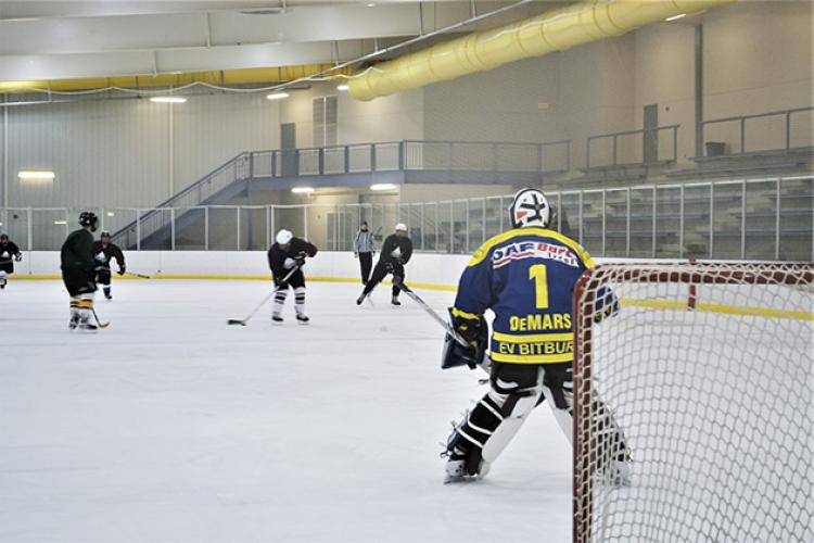 hockeyadult4 This image shows the goalie getting ready to make a save at adult hockey.