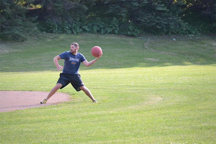 kickballleague This image shows a male throwing the kickball during kickball league.