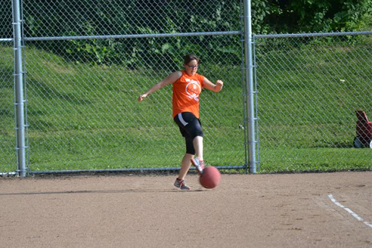 kickballleague3 This image shows a female kicking the ball during kickball league.