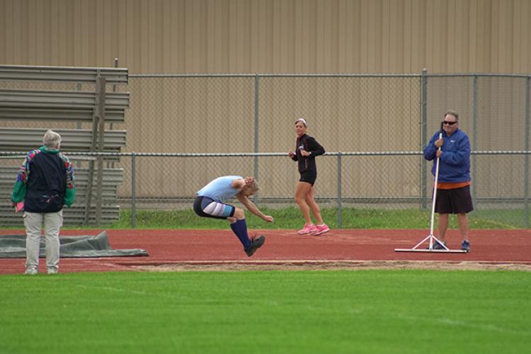 This image shows a male long jumping at the North Dakota Senior Games.