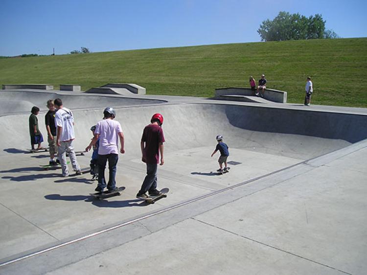 This image shows a group of skateboarders at the skate park.