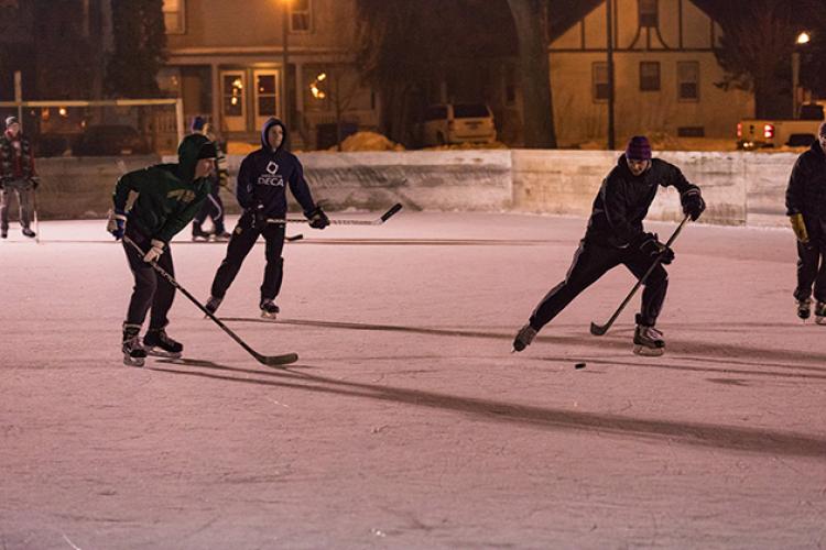 This image shows a people playing hockey during S'mores and More.