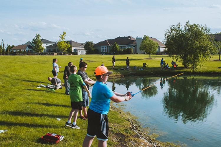 troutfest3 This image shows some kids casting their rods into the pond at Trout Fest.