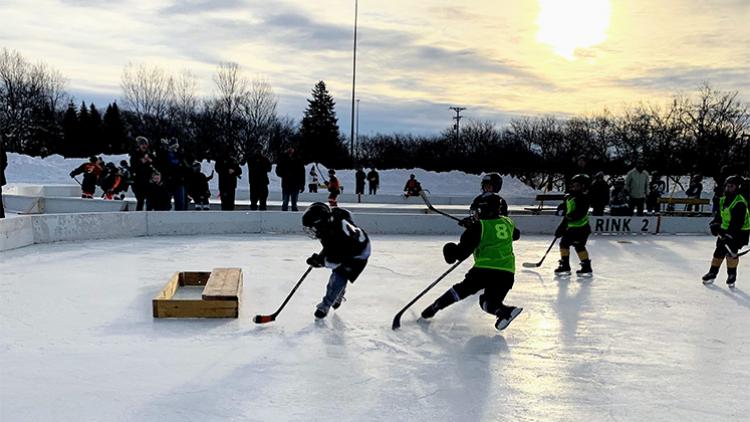 youthpondhockey2 This image shows a player scoring at youth pond hockey.