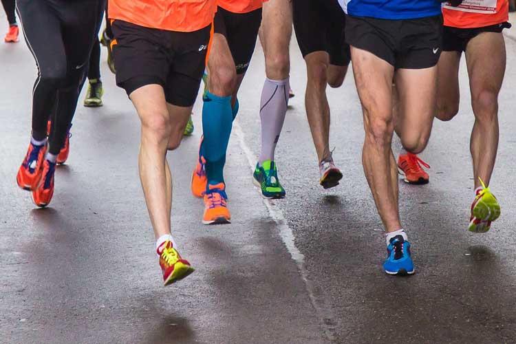 Photo shows legs of running group