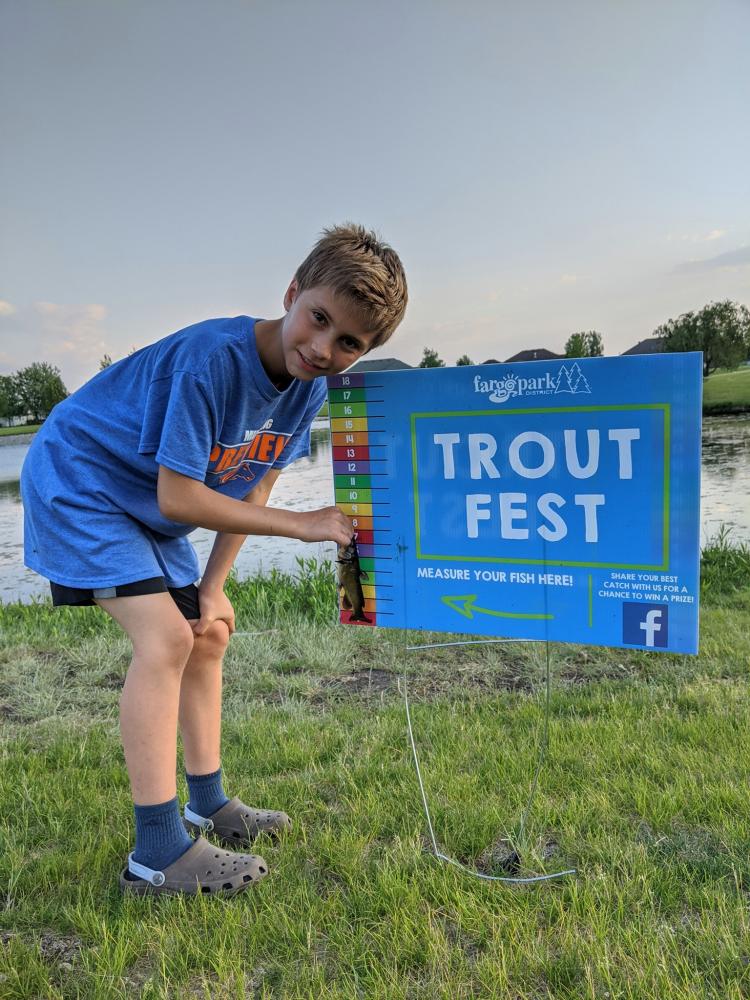 trout fest 2020.jpg This image shows a child measuring a fish at our Trout Fest event.
