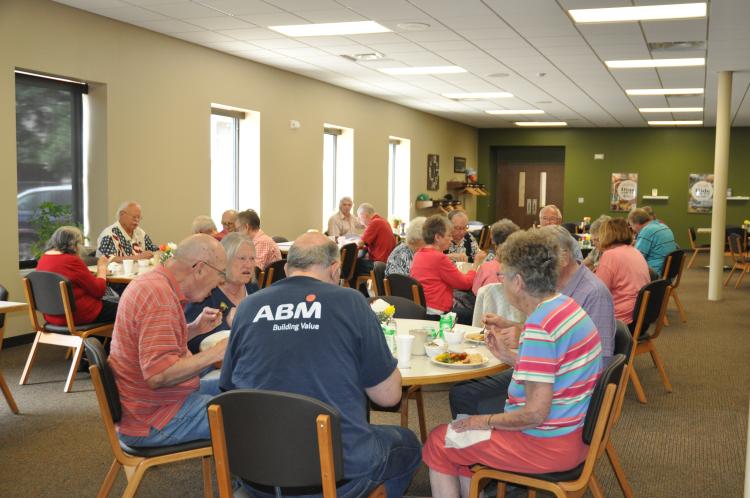 This image shows seniors eating together at Broadway Station