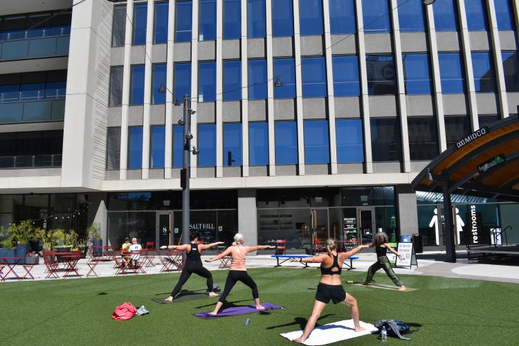 People doing Yoga at Broadway Square