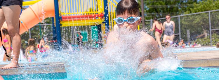 boy cannon balling in pool.