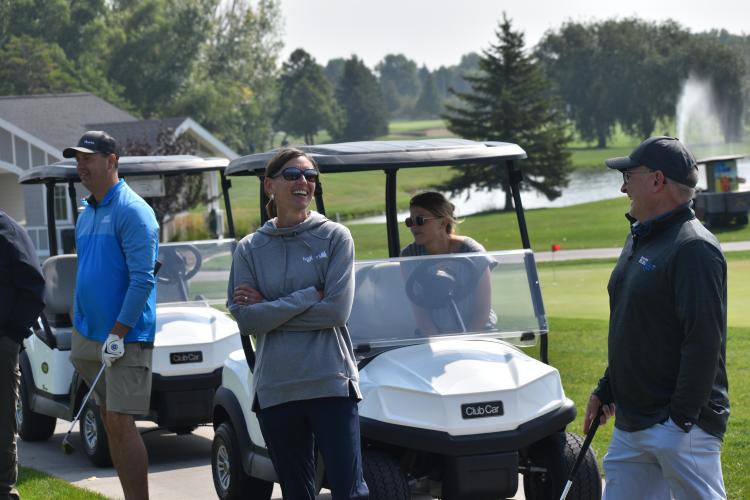 a group of people in golf carts