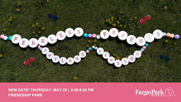 A giant friendship bracelet that spells out "FEARLESS FRIENDS" "TAYLORS VERSION" sitting in a field with dandelions on the bottom pink bar with - NEW DATE Thursday, May 29 | 6:00-8:00 pm - Friendship Park