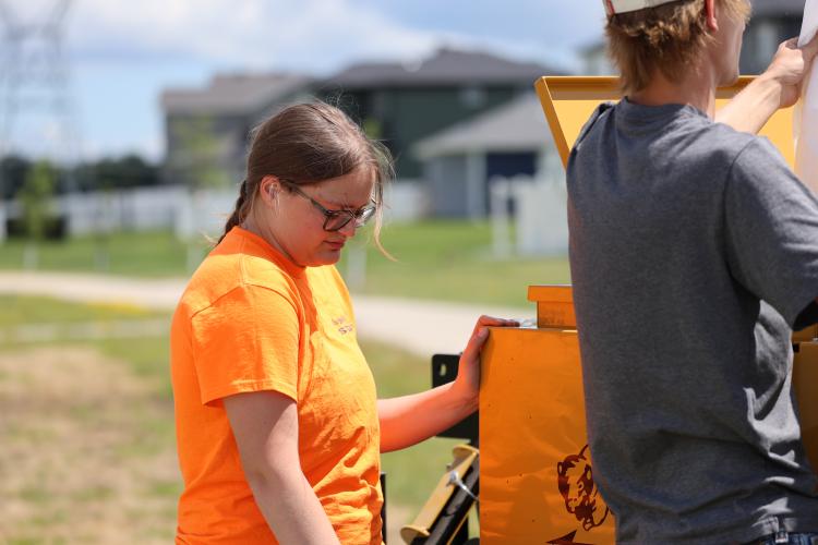 This graphic shows an intern working in a park.