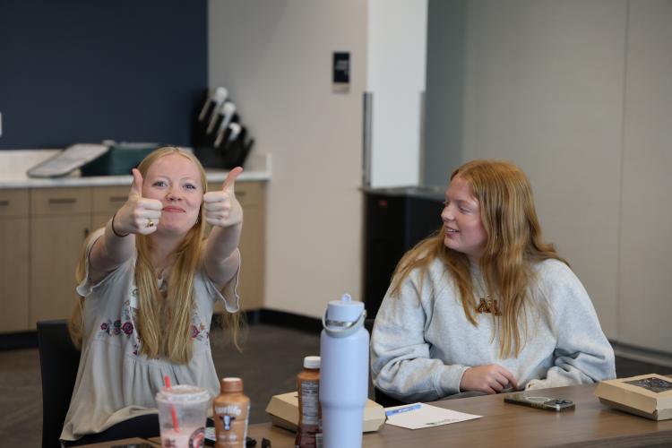 This image shows two girls at a FORGE internship meeting.