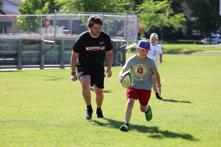 This image shows the recreation intern teaching rugby.