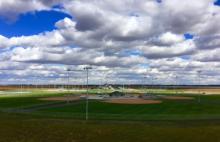 This image shows an aerial view of the concessions building and diamonds at North Softball Complex.