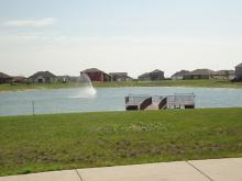 This image shows the fishing pond and dock at Woodhaven South Park.