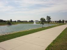 This image shows the fishing pond and trail at Woodhaven South Park.