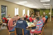 This image shows seniors eating together at Broadway Station