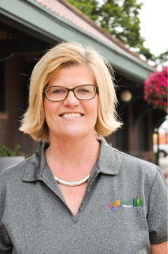 photo of stacy kruger in front of depot.