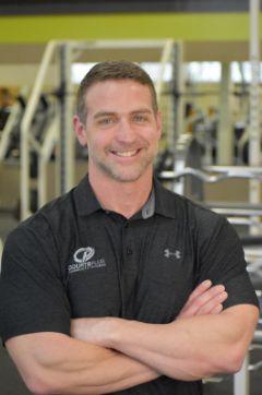 Photo of Kelly Kisell with gym in background