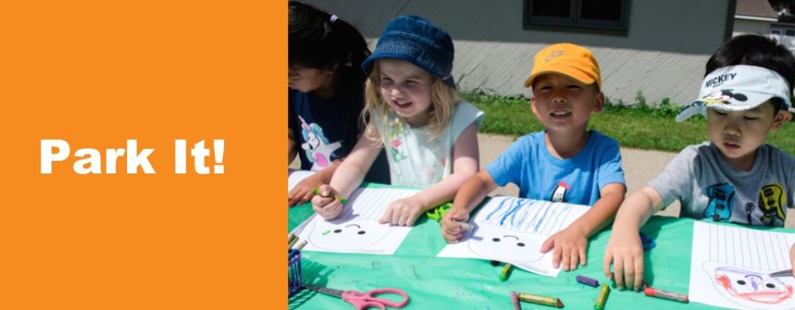 This image shows a graphic of "Park It!" below a photo of four kids at a craft table coloring on a page printed with a cartoon jellyfish.