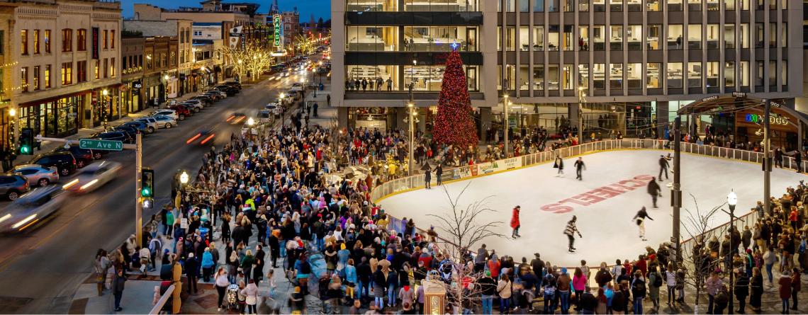 This image shows an aerial view of Broadway Square during the Christmas Tree lighting