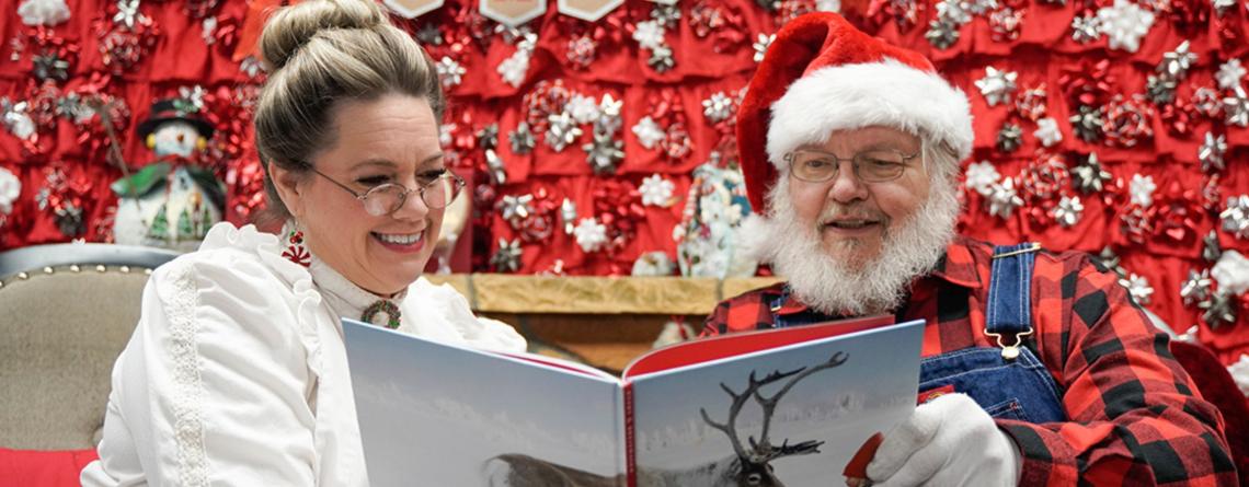 photo of santa and Mrs. Claus reading a book