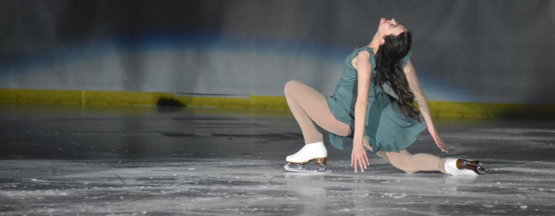 Female figure skater in green dress