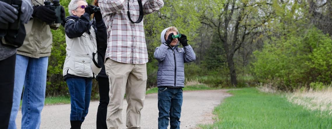 Photo of people looking through binoculars