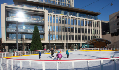 This image shows people skating on the rink at Broadway Square.
