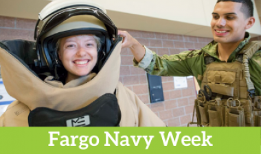 Photo shows girl in bomb suit with navy technician and text that reads "Fargo Navy Week"