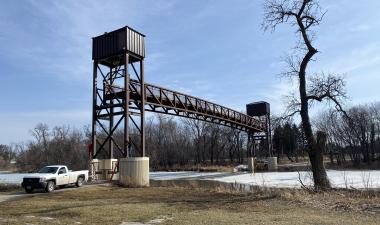 This image shows Fargo Park District employees raising the Lindenwood pedestrian bridge