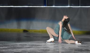 Female figure skater in green dress