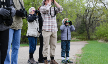Photo of people looking through binoculars