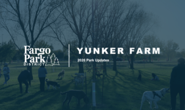 Fargo Park District graphic titled “Yunker Farm: 2026 Park Updates,” featuring a blue-tinted photo of visitors and dogs gathered in an open park beneath leafless trees.
