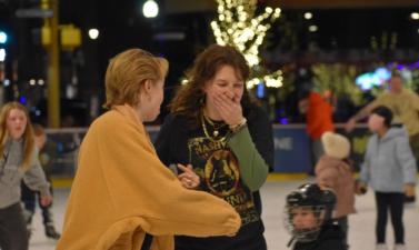 Two girls laughing and skating at Broadway Square