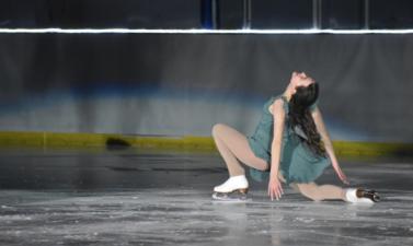 Female figure skater in green dress