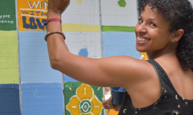 Photo of woman painting community mural