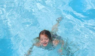 This image shows a girl swimming at Island Park Pool.