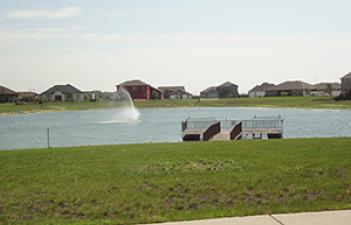 This image shows the fishing pond and dock at Woodhaven South Park.