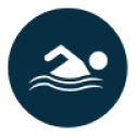 Navy blue circle with white icon of a person swimming in wavy water